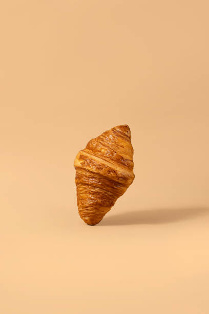 istock A croissant levitates against a pastel peach background 2153358414