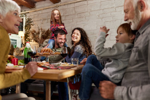 istock Happy extended family talking during lunch in dining room. 2153360296