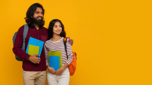 istock Curious indian man and woman students looking at copy space 2153361150