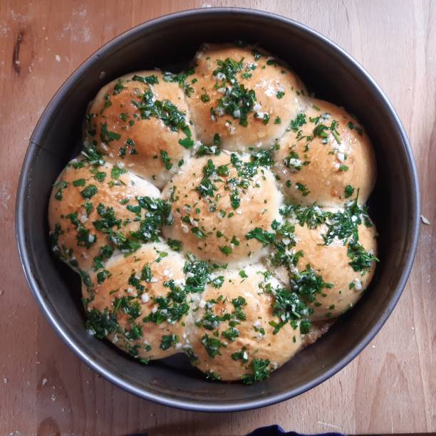 Homemade Herb Butter with Rosemary and Parsley in a Bowl, low angle view. Close-up.