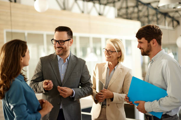 istock Team of happy entrepreneurs talking in a hallway. 2153361772