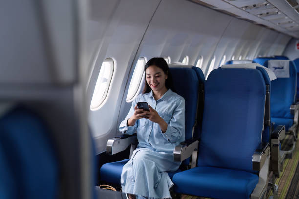 istock Asian people female person onboard, airplane window, using mobile while on the plane 2153365242