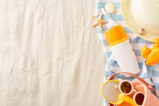 istock Top view of summer beach essentials arranged on a sandy backdrop, perfect for a family outing with small kids 2153365304