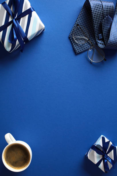 istock Blue Flat Lay with Gifts and Coffee. A vibrant image featuring a coffee cup, wrapped presents, tie, and glasses. Ideal for blogs, articles, and marketing materials about Fathers Day celebration 2153367078