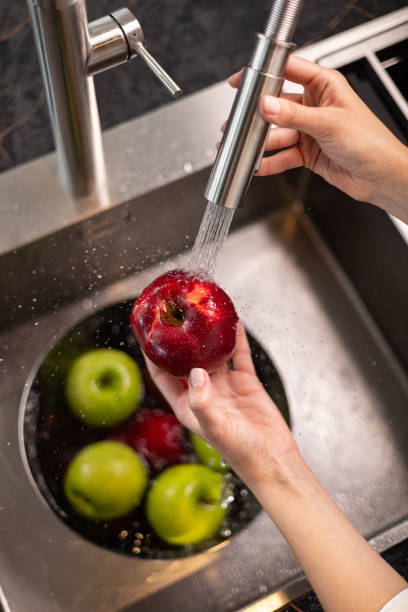 istock Close up of washing organic apple. 2153367518