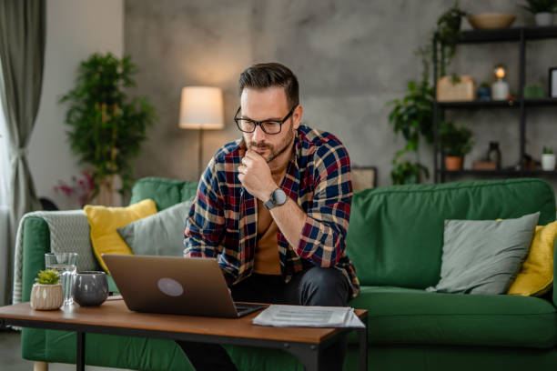 istock One men sitting and working from home on a laptop, using technology concept 2153367806