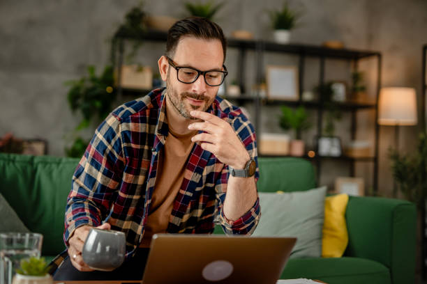 istock One men sitting and working from home on a laptop, using technology concept 2153367898