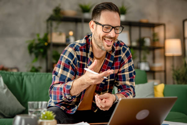 istock One men sitting and working from home, making a video call on a laptop, using technology concept 2153368185