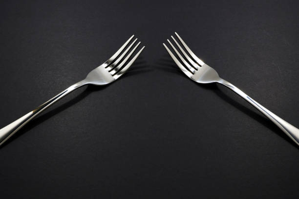 istock Forks pairing together isolated on black background close up view 2153368242