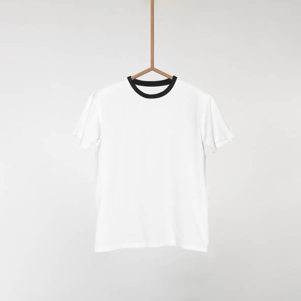 istock Blank White T-Shirts Mockup Hanging on Grey Wall: 3D Rendering 2153370960