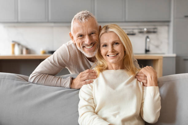 Senior man hugging woman from behind