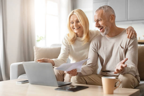 istock Happy couple with papers and laptop discussing 2153371010