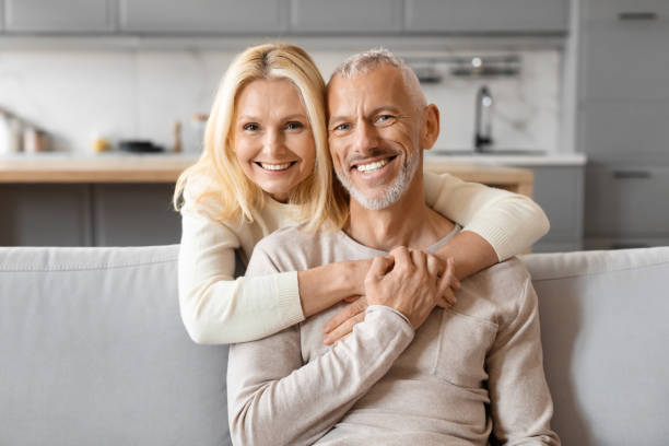 istock Loving beautiful elderly woman hugging her husband, home interior 2153371048
