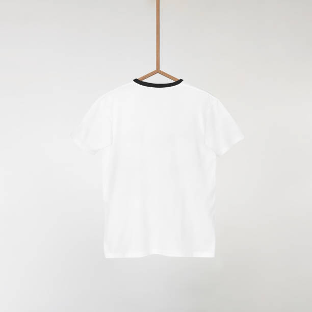 istock Blank White T-Shirts Mockup Hanging on Grey Wall: 3D Rendering 2153371117