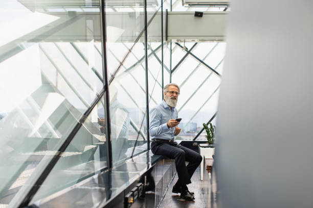 istock Senior Business Executive Engages with Smartphone Technology 2153372156