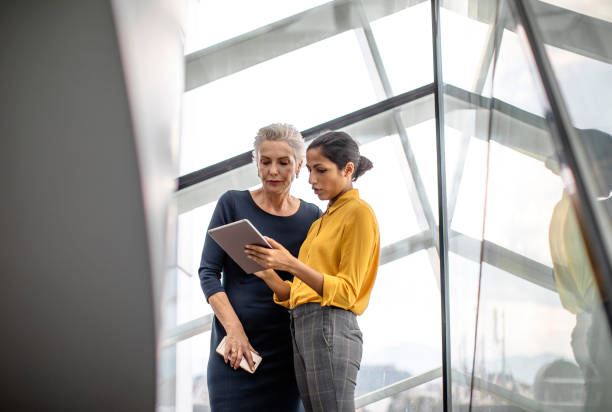 istock Diverse Professionals Collaborate with Laptop at Conference 2153372248