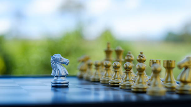istock gold  knight Against whithe background, International chess, ideas and competition and strategy, chess board game competition business concept. 2153372414