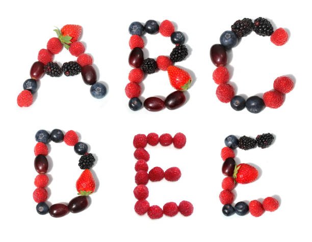 istock letter A B C D E made from raspberry, blackberry, strawberry with green leaf, blueberries, grape. isolated berries letters for party cake decoration dessert event invitation card 2153373970