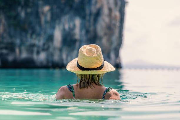 istock A Woman In A Hat Enjoying A Serene Swim with a View 2153376087