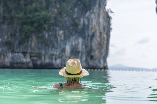 istock Woman Swimming At Tropical Beach 2153376088