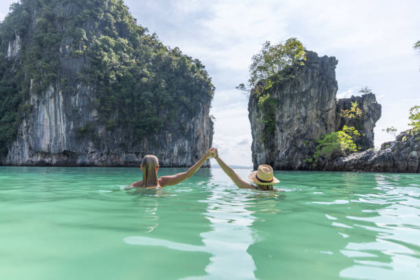 istock Two Friends Holding Hands In Water 2153376115