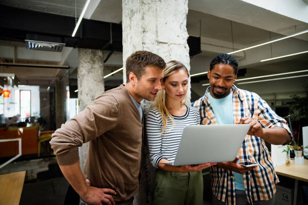 istock Diverse business colleagues gather in boardroom brainstorm discuss financial statistics together 2153377224