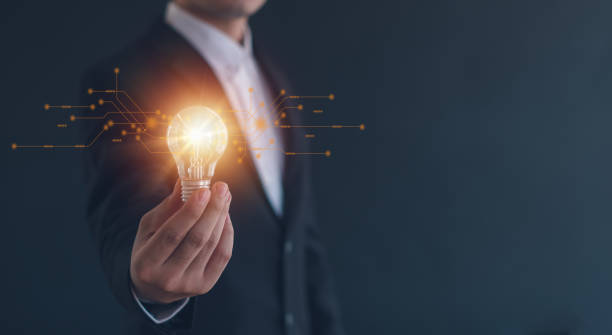 istock Idea innovation and inspiration concept.Hand of man holding illuminated light bulb, Idea innovation and inspiration concept.  creativity with bulbs that shine glitter, Concept for success. 2153377228