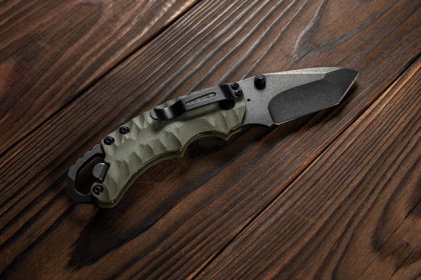 istock Tactical knife on a wooden background 2153380428