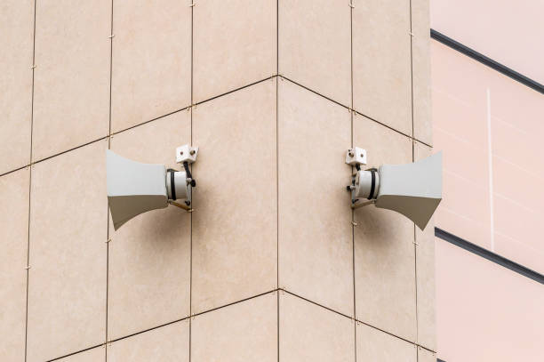 istock Two large speakers are mounted on a building. The speakers are white 2153380604