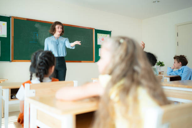 istock Teacher and students, Learn and study in a classroom of school where youngsters sit and listen attentively. 2153382876