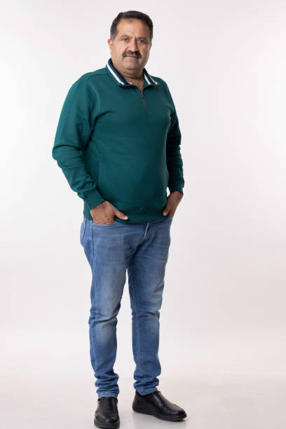 istock Happy mature man with arms crossed and looking at camera while standing against white background 2153383833