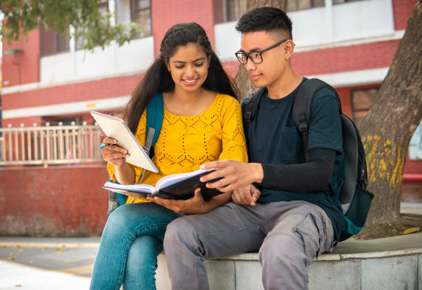 istock Multiethnic college student friends studying together at campus. 2153386037