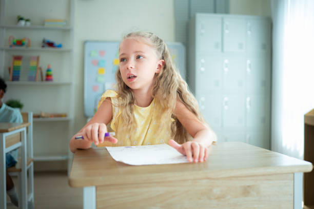 Students learn and study in a classroom of school where youngsters sit and listen attentively.