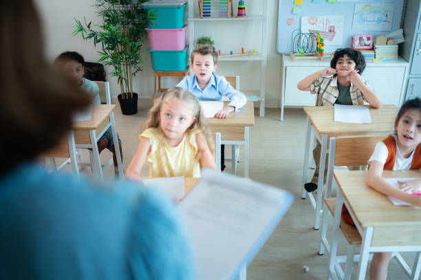 istock Teacher and students, Learn and study in a classroom of school where youngsters sit and listen attentively. 2153389181