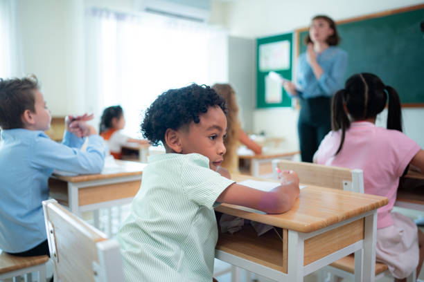 istock Teacher and students, Learn and study in a classroom of school where youngsters sit and listen attentively. 2153389198