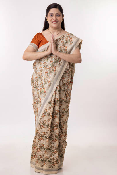 Beautiful Indian woman in sari greeting with namaste gesture