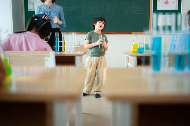 Elementary school students observing with a microscope