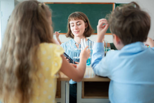 istock Teacher and students, Learn and experiment with science in a school science classroom. 2153391115