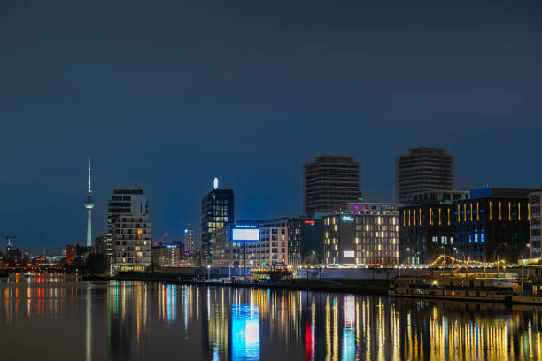 Germany, Berlin, March 06, 2024 - Cityscape of Berlin over Spree river at night, Berlin Friedrichshain
