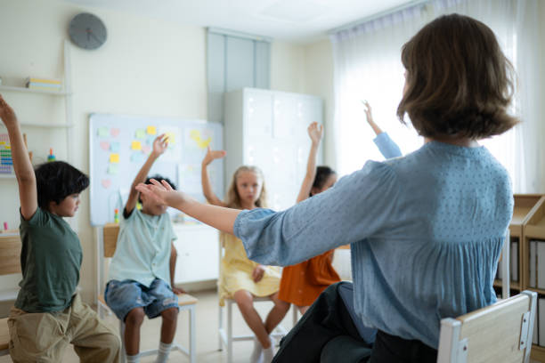 istock Teacher and students, Learn and study in a classroom of school where youngsters sit and listen attentively. 2153392676
