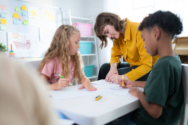 istock Teacher and students, Learn and study in a classroom of school where youngsters sit and listen attentively. 2153393258