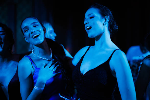 istock Young women dancing under the blue neon lights 2153393299