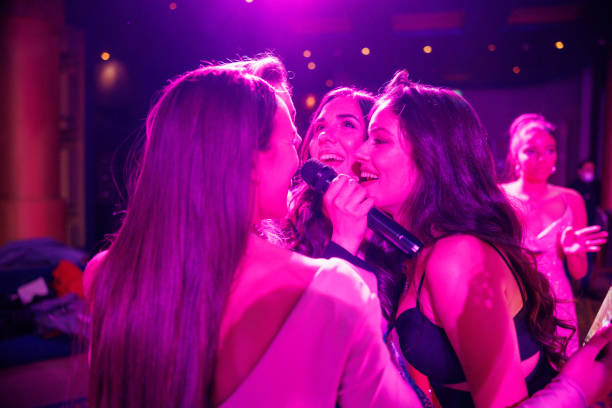 istock Cheerful young women dancing under the pink neon lights 2153393394