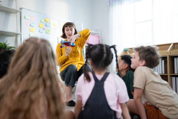 istock Teacher and students, Learn and study about airplanes in a classroom of school where youngsters sit and listen attentively. 2153393599