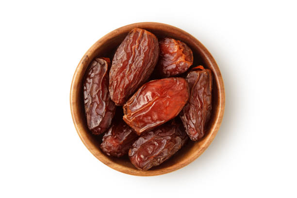 istock Dried dates in wooden bowl on white background 2153394014