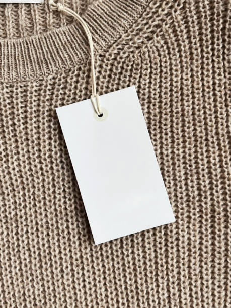 istock White paper tag on a brown woolen sweater 2153394539