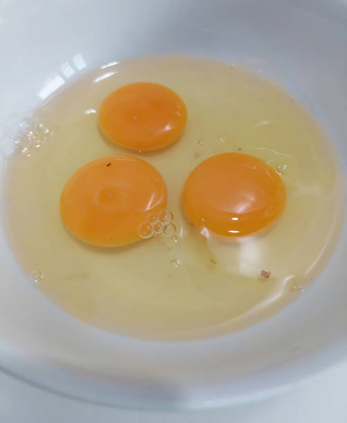 istock Prepare the food by cracking fresh eggs into a white bowl. 2153395310