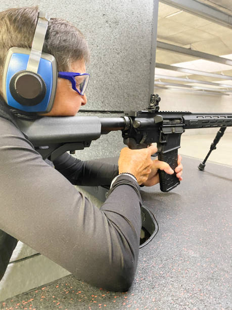 istock Female senior citizen shooting an AR-15 rifle 2153395432