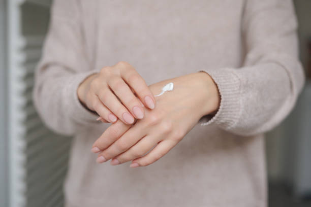 istock Woman applying hand cream at home 2153395654