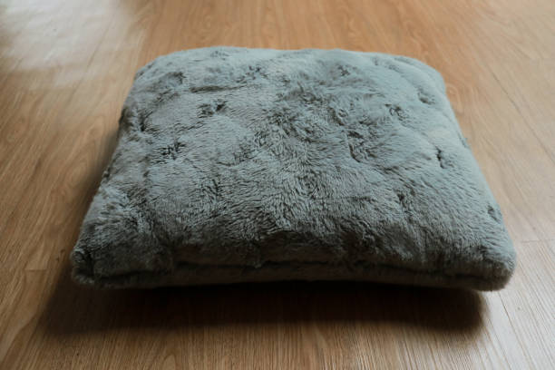 istock Grey soft pillow on wooden background 2153397041